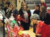 People who attended the BetterCARE Christmas Gala Sunday look over baskets and decide where to place their raffle tickets.